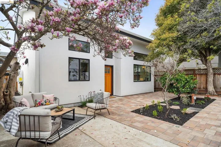 Rear view of house with a patio area and stucco siding
