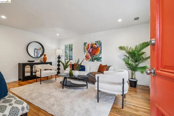 Living area with light wood-style flooring and recessed lighting