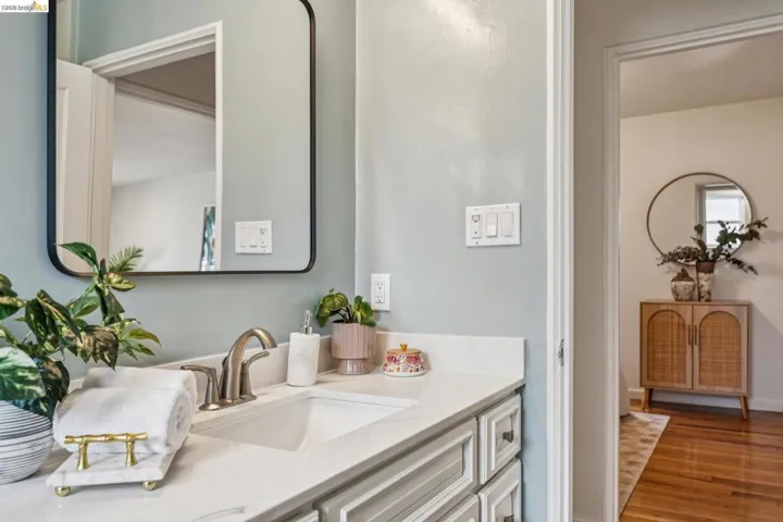 Bathroom featuring vanity and wood finished floors