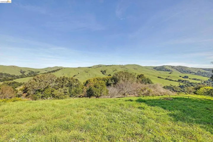 View of mountain backdrop featuring rural landscape