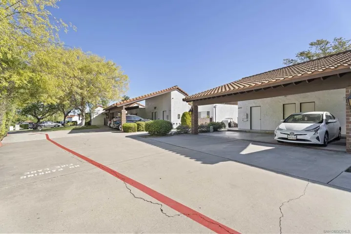 Driveway cul-de-sac access to the carport, with 3 extra parking spaces