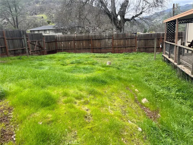 Backyard with deck across back of house
