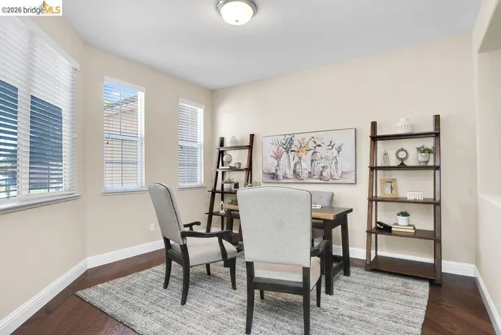 Dining area featuring an office area and dark wood-style flooring