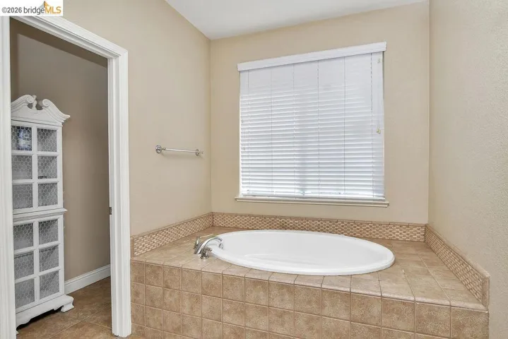 Bathroom featuring a bath and tile patterned floors