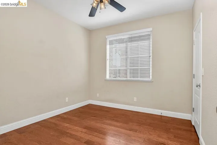 Unfurnished room featuring wood finished floors and ceiling fan