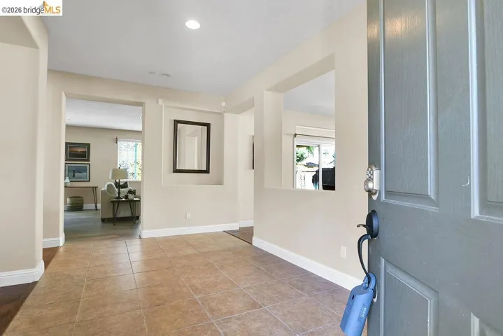 Foyer entrance with healthy amount of natural light, light tile patterned floors, and recessed lighting