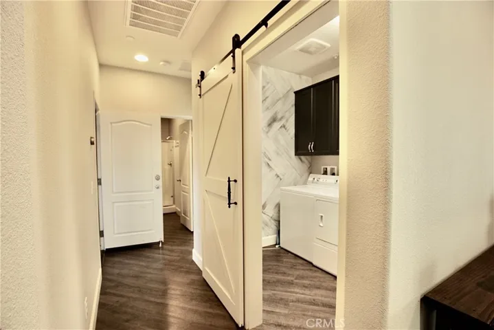 Hallway leading to laundry room and 3rd secondary bedroom