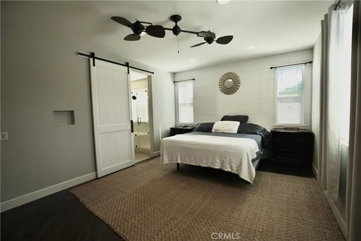 Beautiful barn door leading to oversized primary bathroom