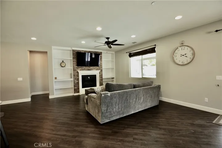 Huge family room featuring stone faced gas fireplace connected to open kitchen