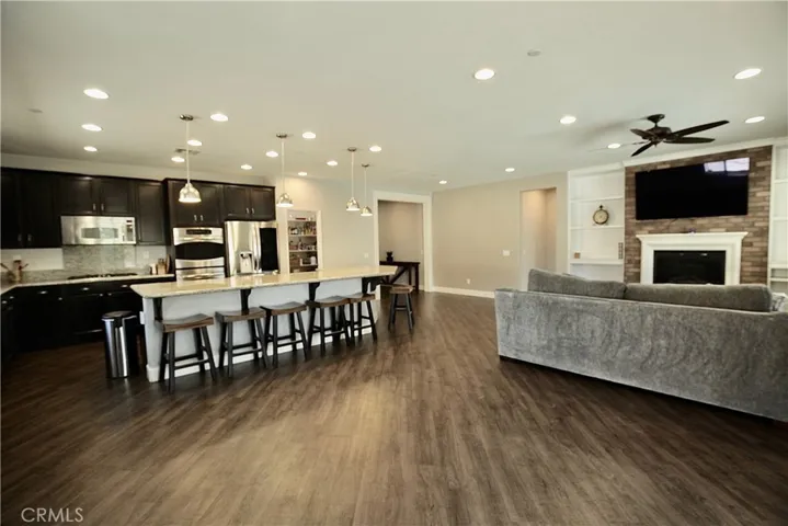 Massive granite countertop with room for 6+ barstools connected to family room