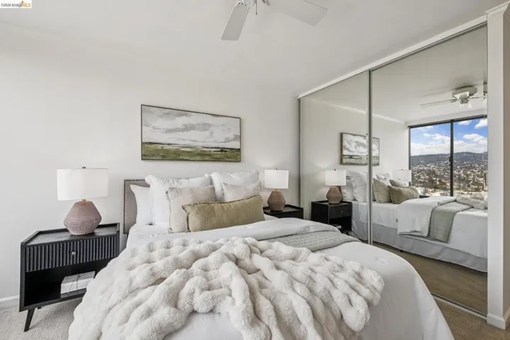 Carpeted bedroom featuring a closet, crown molding, and a ceiling fan