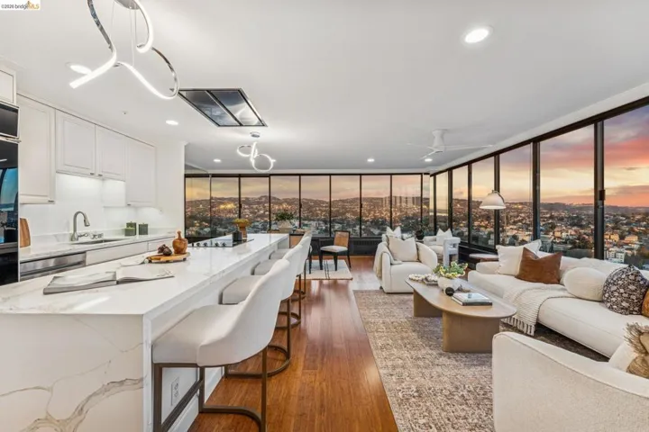 Living room featuring expansive windows, dark wood finished floors, recessed lighting, and a ceiling fan