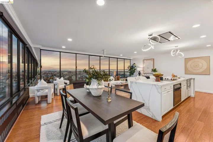 Dining room featuring light wood-type flooring, a ceiling fan, recessed lighting, crown molding, and floor to ceiling windows