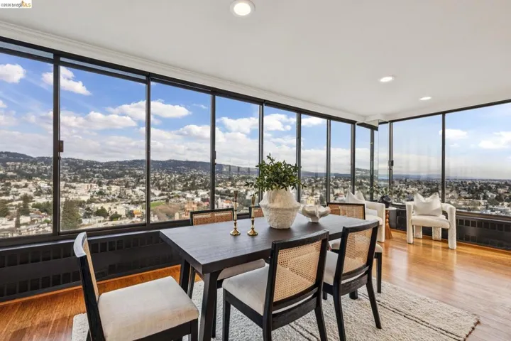 Sunroom with hardwood / wood-style floors, floor to ceiling windows, recessed lighting, and a mountain view