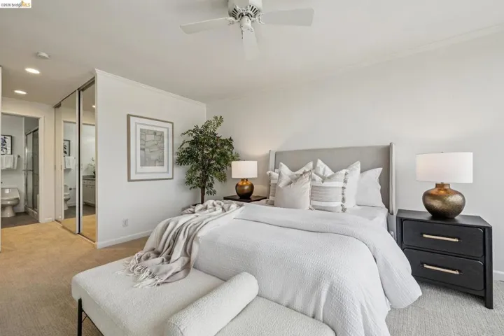 Bedroom featuring connected bathroom, light colored carpet, a closet, ornamental molding, and recessed lighting