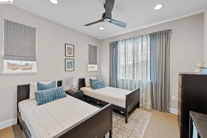 Bedroom with ceiling fan, light colored carpet, and recessed lighting