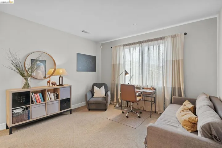 Office space with light carpet and baseboards