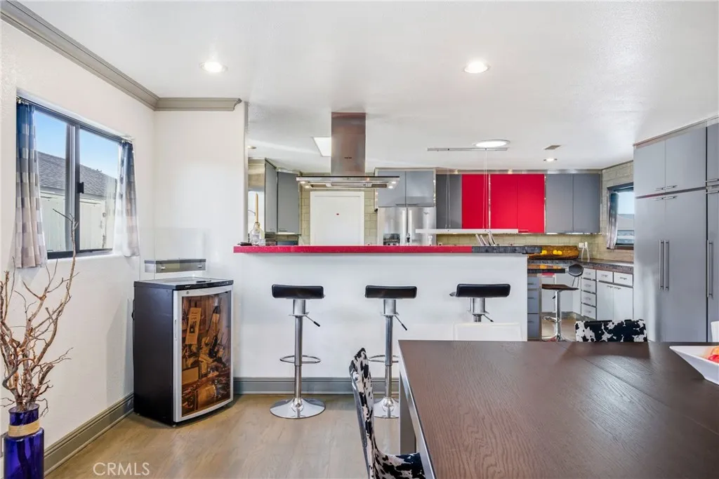 Elevated bar seating connects the kitchen to the dining and living areas.