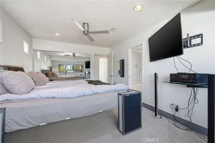 Mirrored closet doors and a spacious nook with excellent storage potential.