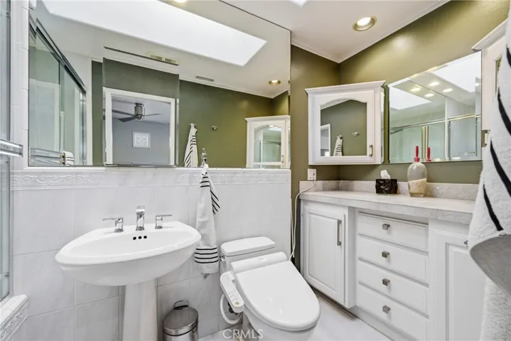 Upgraded en-suite bathroom with a skylight for added natural light.