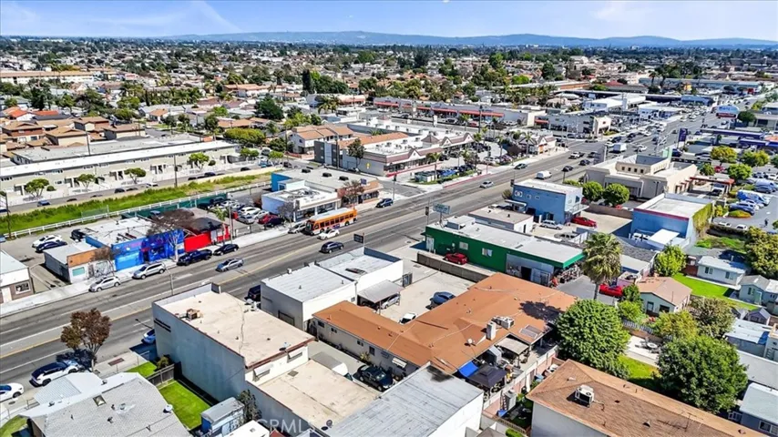 Aerial View of SFR (Look how huge it is!!) along with carport parking space for units and Commercial Building