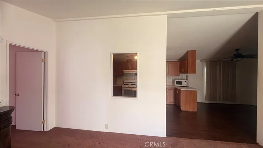 Living Room with Peep Window to Kitchen