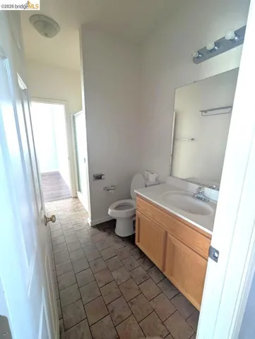 full bath featuring vanity, a stall shower, and light tile patterned floors