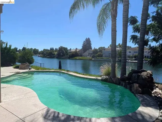 swimming pool featuring a water view