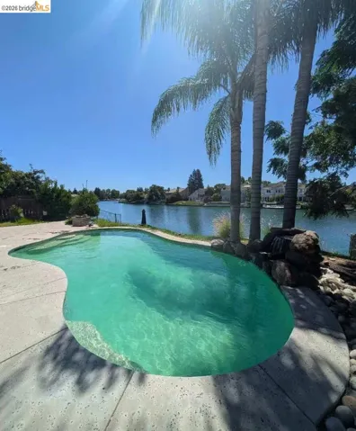 swimming pool featuring a water view