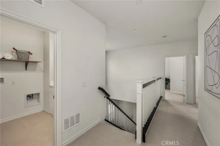 2nd level landing with large upstairs laundry room