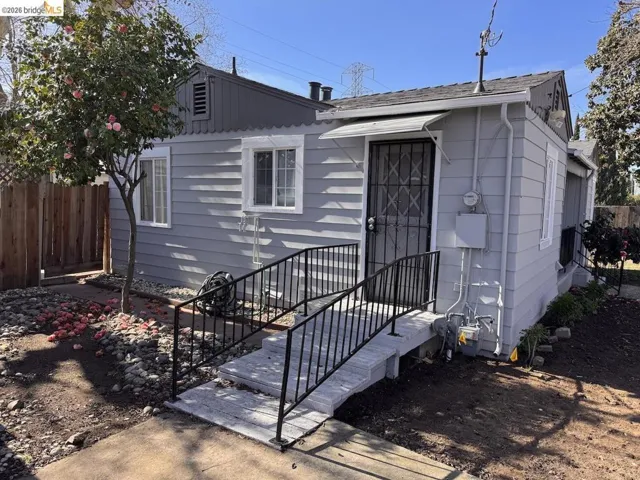 View of front of house featuring a shingled roof