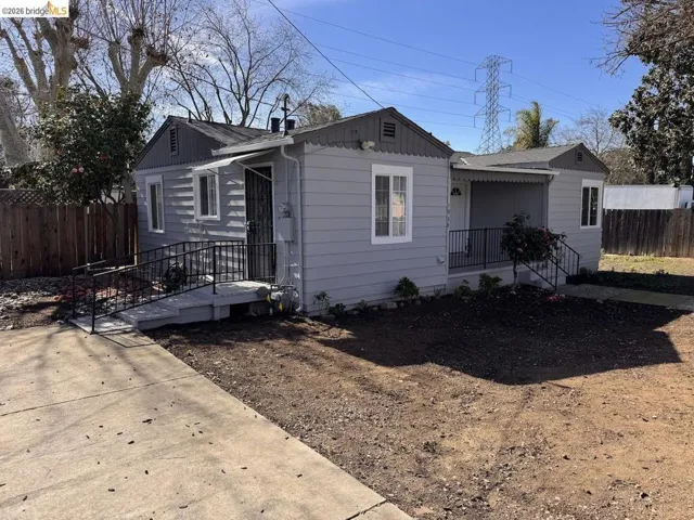 Bungalow-style house featuring roof with shingles