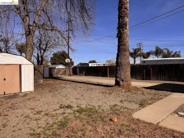 Fenced backyard with a storage shed