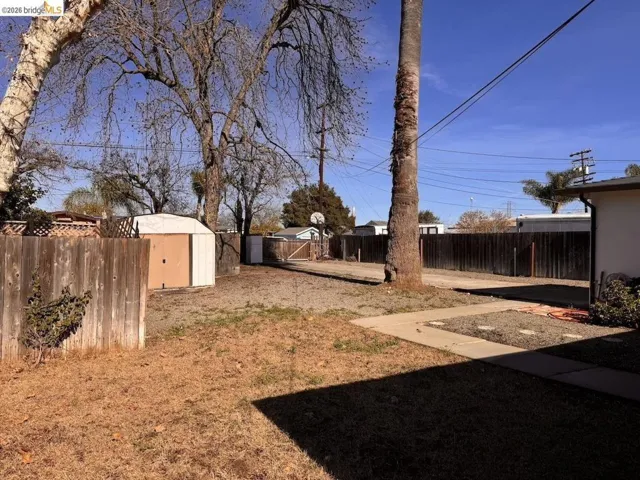 Fenced backyard with a storage shed