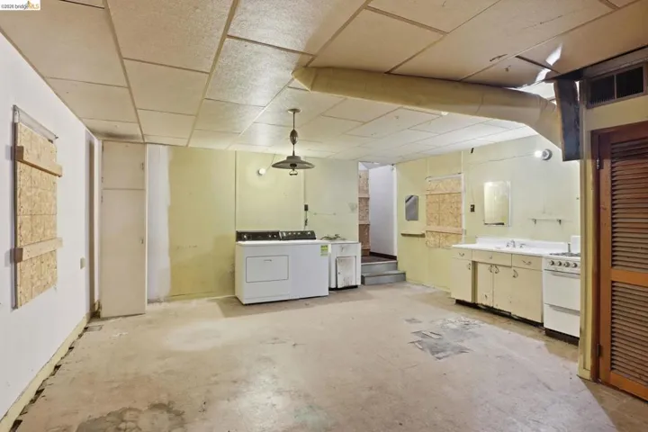 Basement featuring separate washer and dryer and a paneled ceiling.