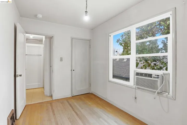 Bedroom featuring light wood-style floors and cooling unit