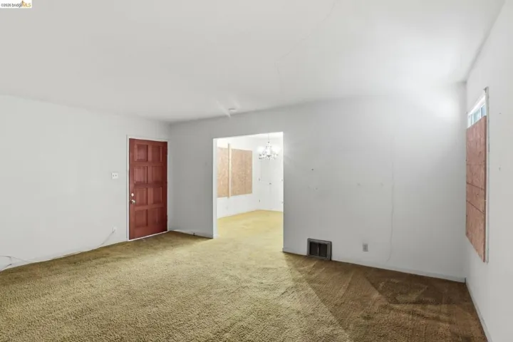 Featuring light carpet and suspended lighting