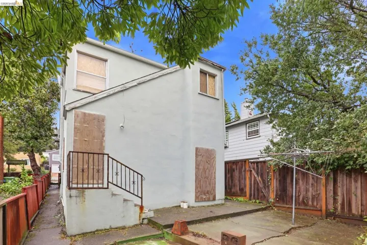 Rear view of house featuring stucco siding.