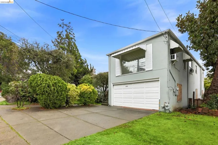 View of property exterior featuring stucco siding, an attached garage, and concrete driveway