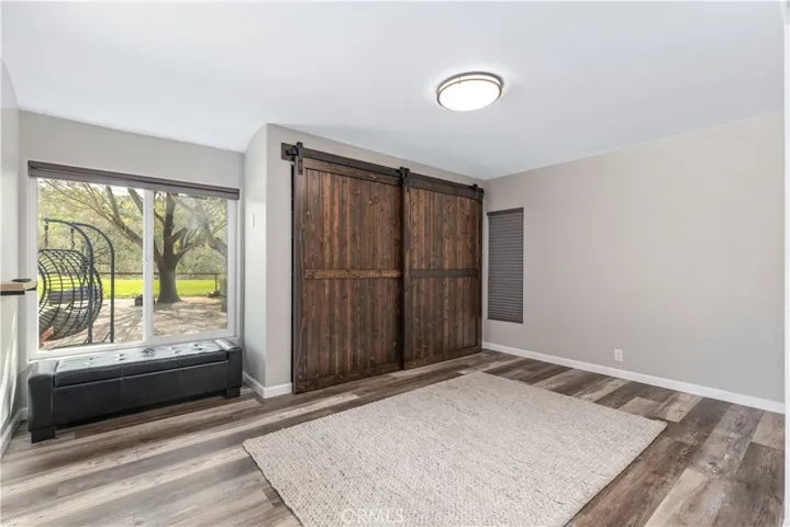 More closet or storage space behind the barn doors.  Office or lounge area with a gorgeous view.