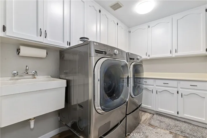 Laundry room with sink and plenty of storage