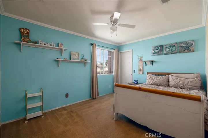 Bedroom 3 upstairs with ceiling fan, crown molding and large walk in closet.