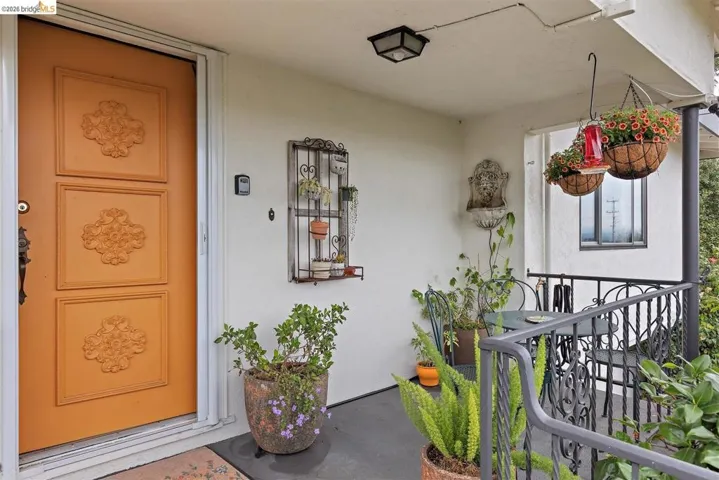 Property entrance featuring stucco siding and a porch