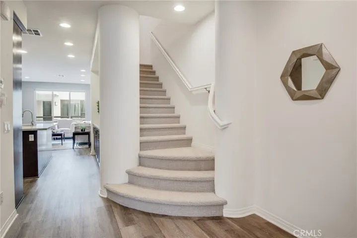 It's all about the entry.  Beautiful foyer with dramatic stairs, wide plank flooring, new paint and more