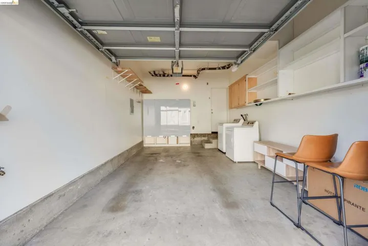 Garage featuring washer and clothes dryer