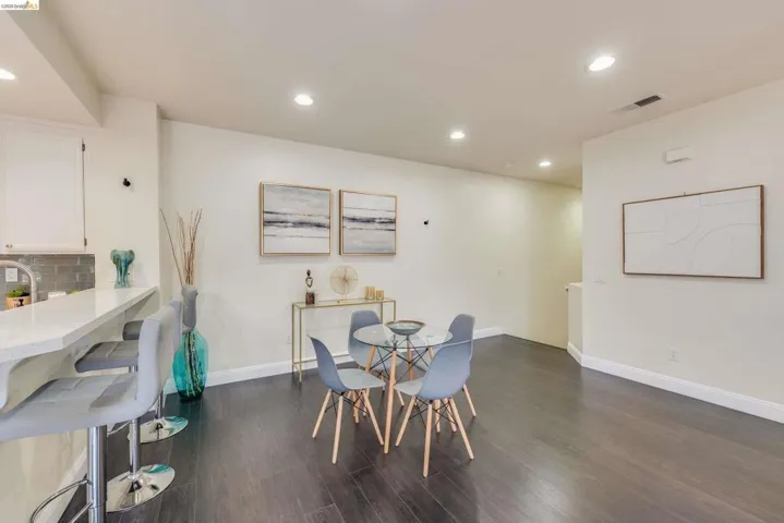 Dining space featuring recessed lighting and dark wood-type flooring