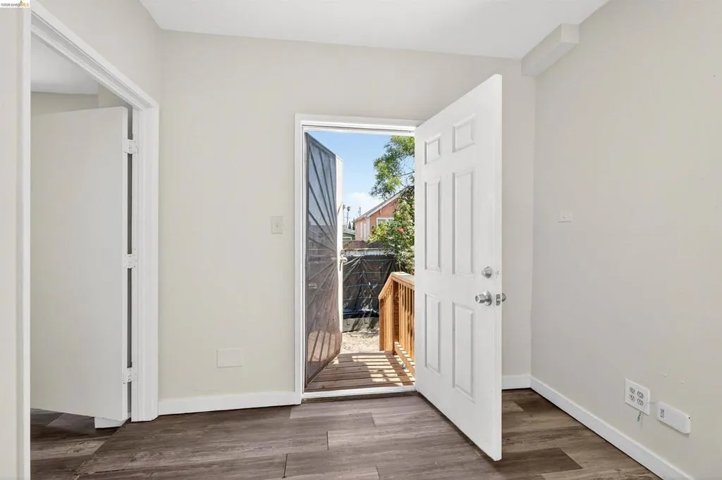 Wood-finish flooring throughout, complemented by light neutral wall tones and white​​‌​​​​‌​​‌‌​​‌​​​‌‌​​​‌​​‌‌​​‌‌​​‌‌​​​​ baseboards