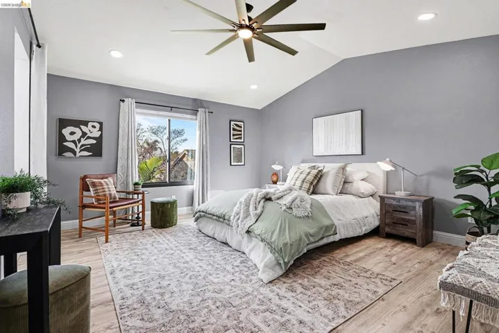 Bedroom featuring lofted ceiling, recessed lighting, light wood-type flooring, and a ceiling fan