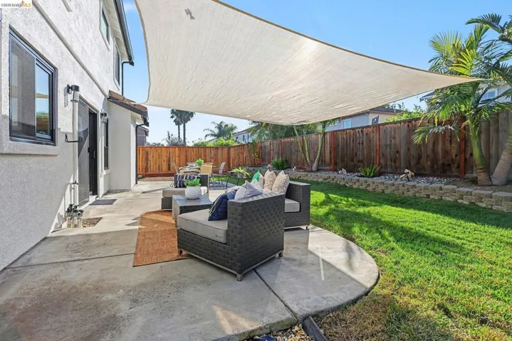 Fenced backyard featuring an outdoor lounge area and a patio area