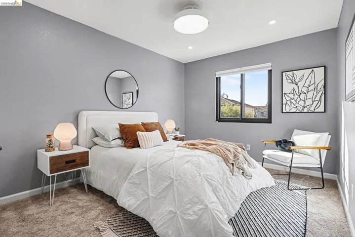 Bedroom featuring light colored carpet